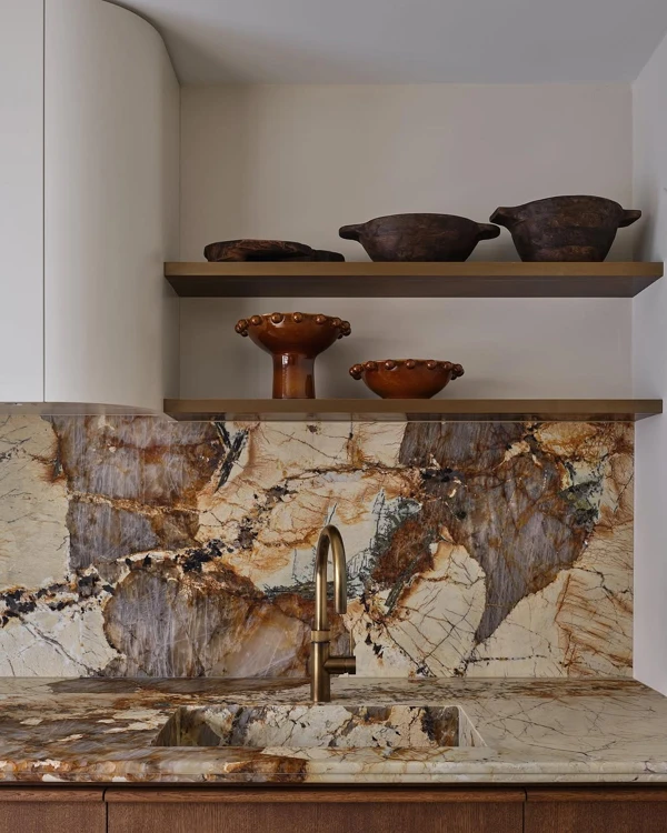 Art Deco Kitchen with Marble Backsplash and Vintage Pottery
