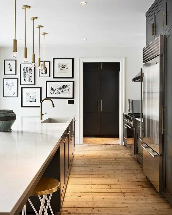 Black framed gallery wall above kitchen counter