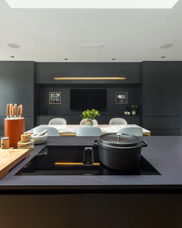 Black Kitchen Island with Warming Gold Lighting
