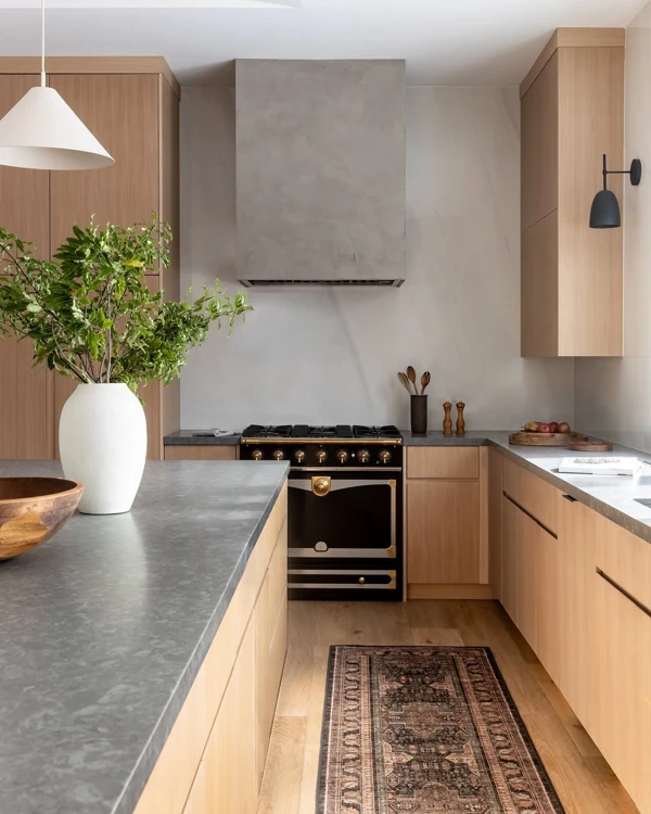 Wood Cabinetry Frames Sleek Black Appliances