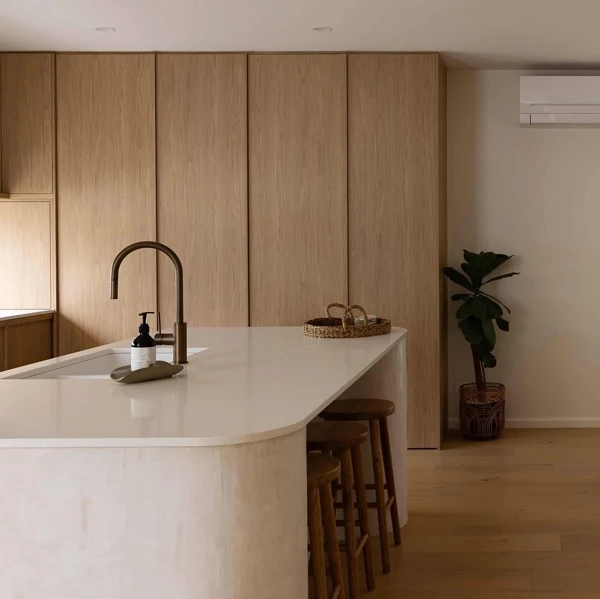 Curved Island Anchors Minimalist Space