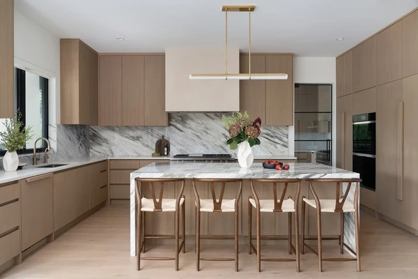 Taupe Cabinetry With Marble Statement Wall