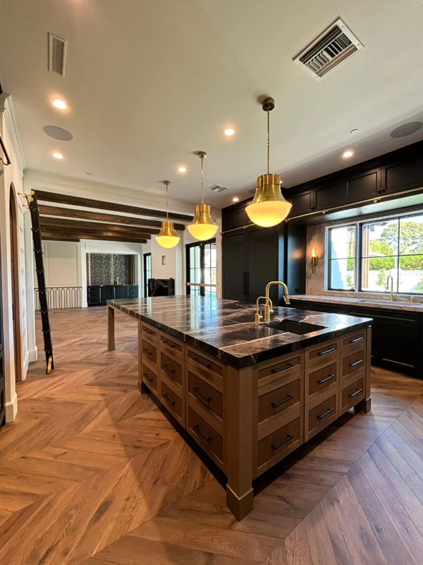 Brass Pendants Elevate Dark Kitchens