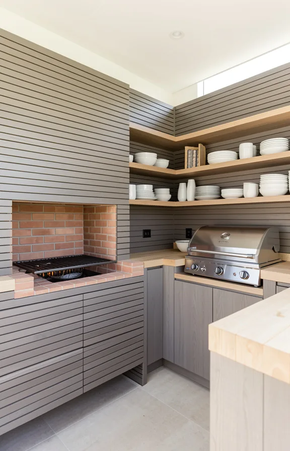 built-in brick cooking area, open shelving displaying dishes