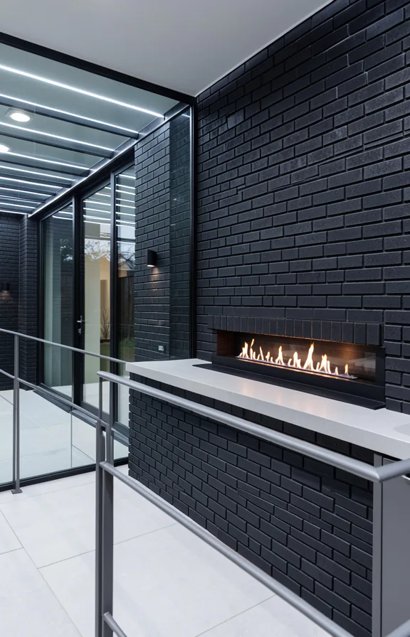 frameless glass panels adjacent, modern linear fireplace feature