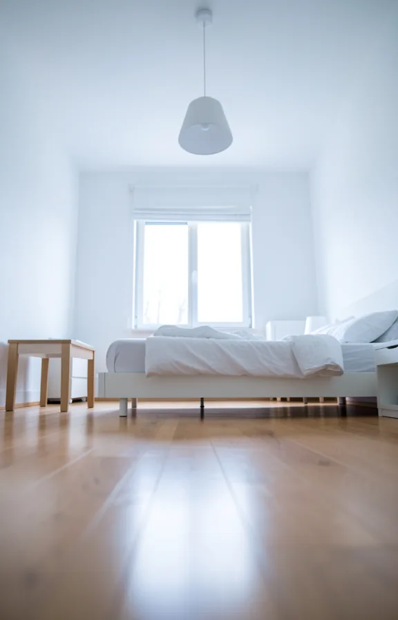 Low-angle bedroom view with bed frame near floor