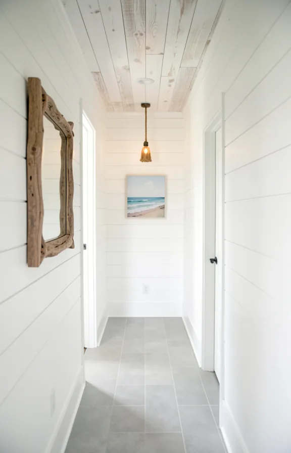 Coastal hallway with white shiplap walls floor to ceiling