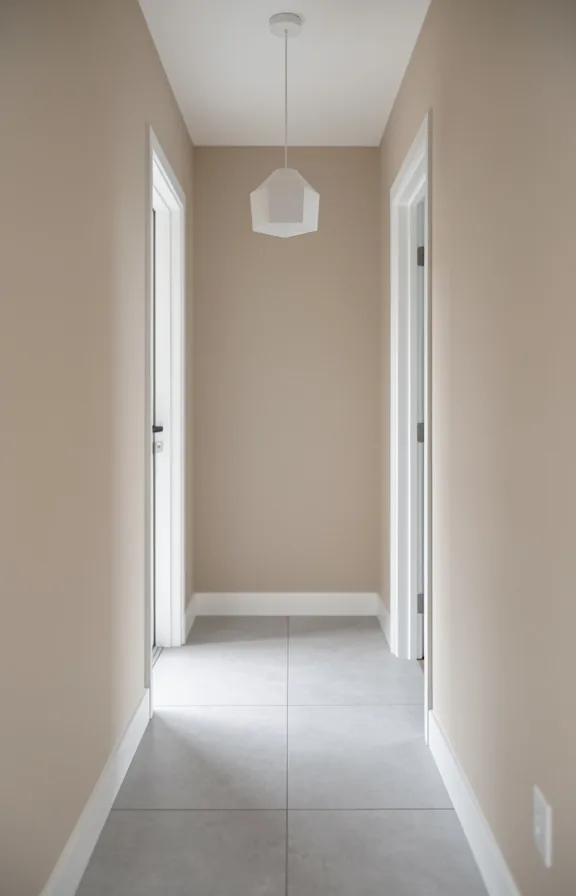 Minimal hallway with soft beige walls, light gray tile flooring